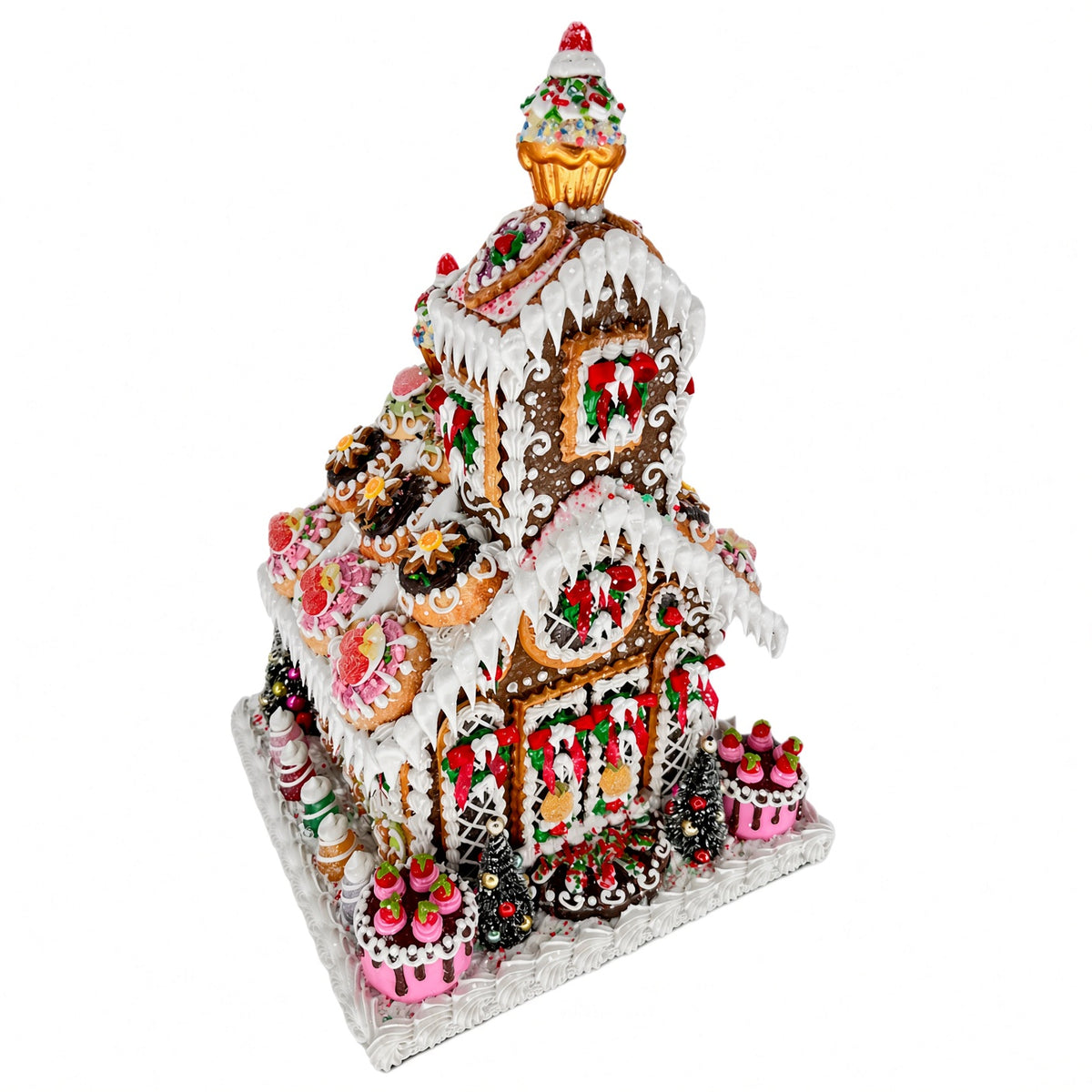 Three-quarter angle view of Sweet Savannah Gingerbread Chapel showing the tiered structure, cupcake spire, and dessert-style medallion cookies along the rooflines