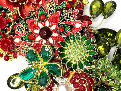 Close-up of Cardinal Rose jeweled Christmas wreath featuring a red and white jeweled poinsettia with garnet center, emerald rhinestone flowers, a red jeweled rose, and sage green teardrop rhinestones