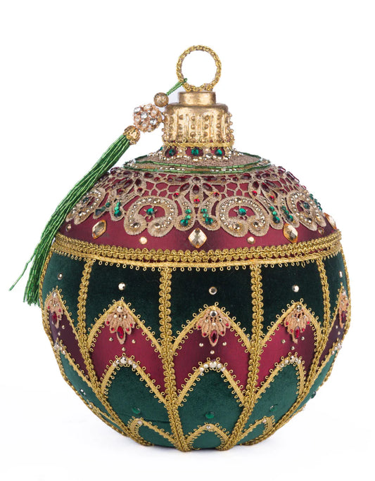 Katherine's Collection Christmas Castle keepsake box shown on a plain white background, featuring a jeweled gold cap with beaded tassel, an ornate lace medallion top, and alternating burgundy and dark green panels trimmed in gold beadwork.
