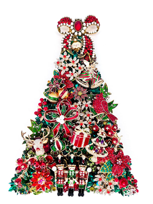 Jeweled Christmas tree sculpture adorned with red, green, and gold rhinestones, nutcrackers, cardinal, poinsettias, reindeer, and a jeweled bow topper