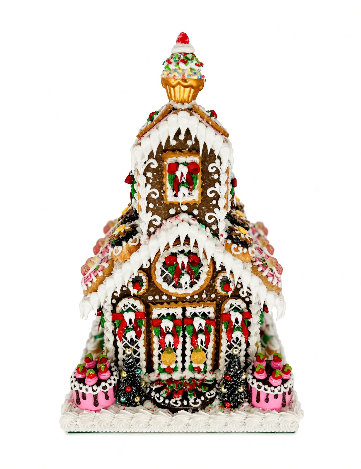 Front view of Sweet Savannah Gingerbread Chapel showing the cherry-topped cupcake spire, icicle-draped rooflines, wreath-decorated windows, and dessert-style medallion cookies lining the roof