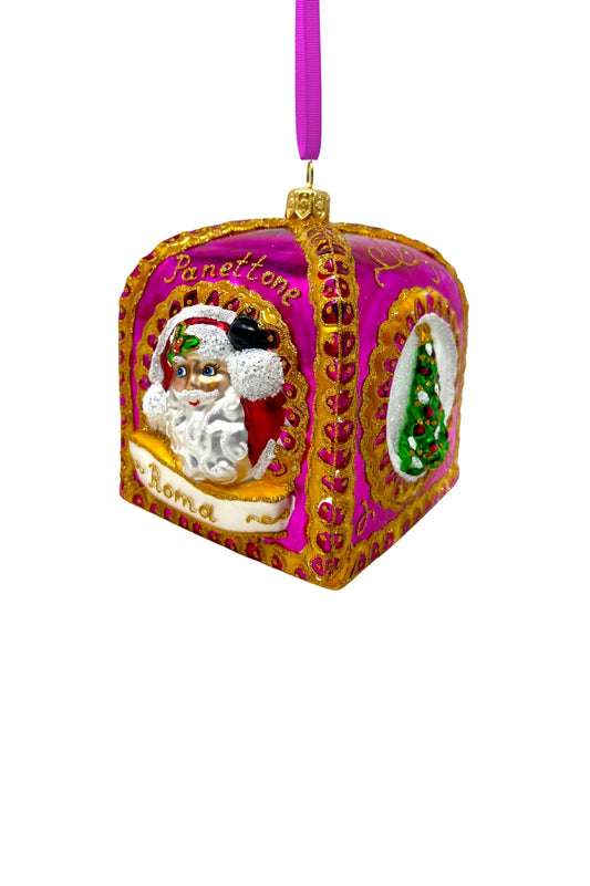 Rounded square glass Christmas ornament shown at an angle, featuring the "Panettone" Santa face design bordered in gold on a fuchsia background, with a matching green Christmas tree inset visible on the adjacent face.
