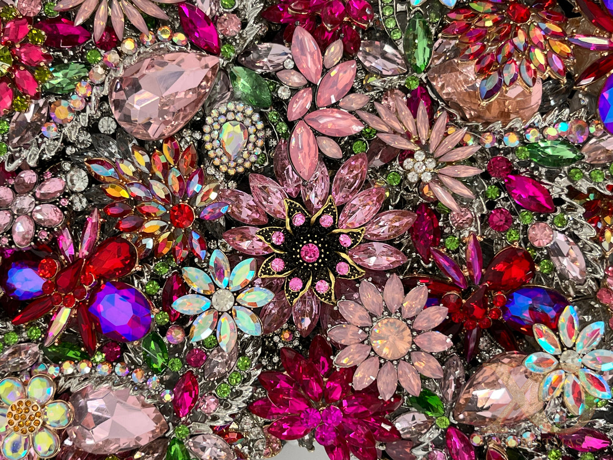 Close-up of Hot Pink Jeweled Wall Art Pair showcasing pink marquise flowers, aurora borealis accents, red and fuchsia rhinestone clusters, and green leaf rhinestone details