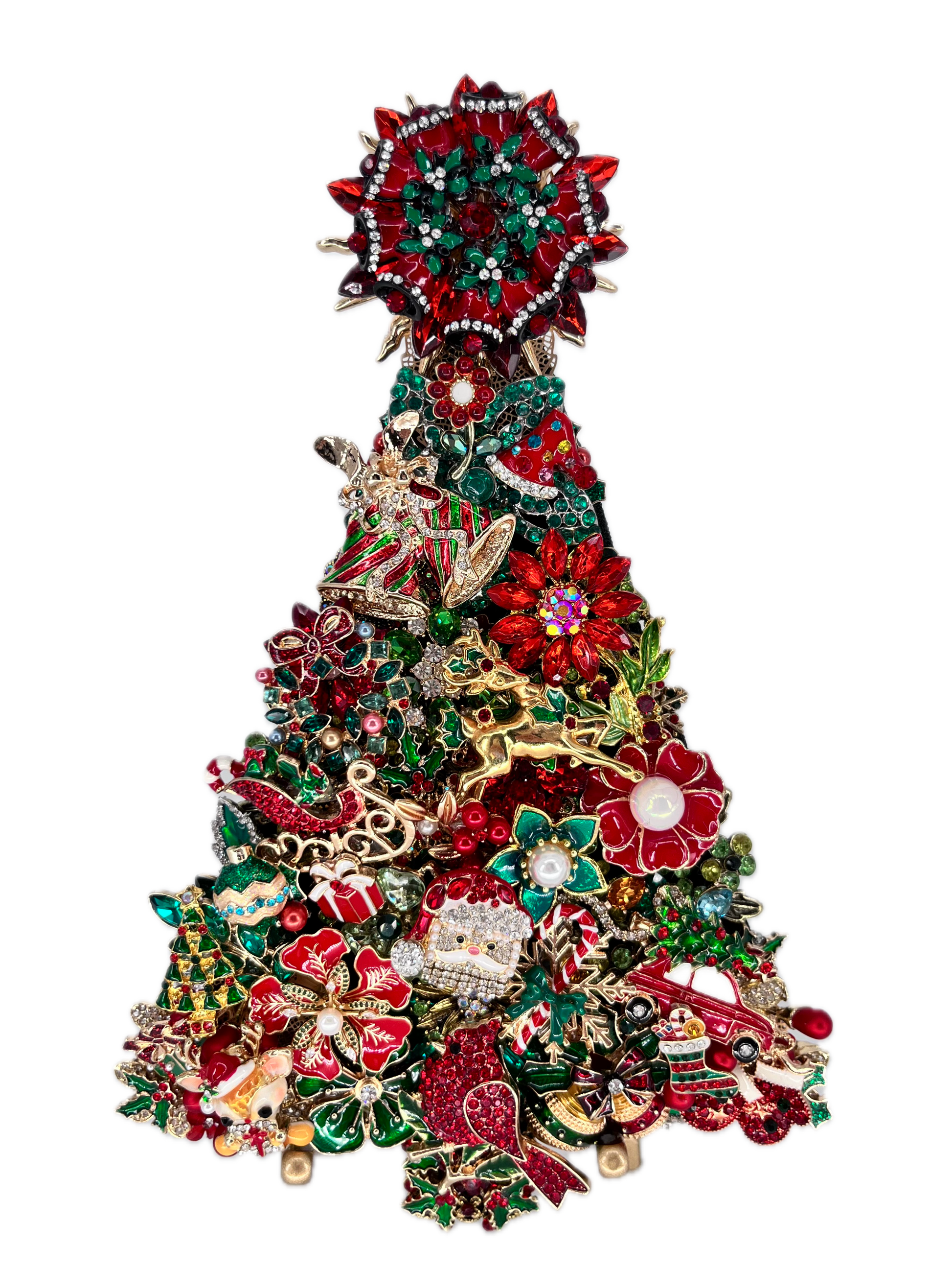 A Christmas tree-shaped art piece made of densely packed holiday jewelry and charms, including red and green enamel flowers, rhinestone accents, a Santa figure, ornaments, and a tree topper, shown on a plain white background.