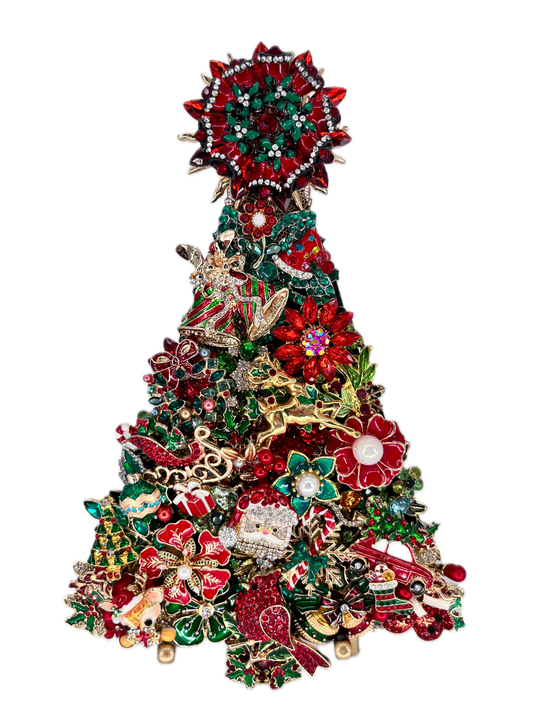 A Christmas tree-shaped art piece made of densely packed holiday jewelry and charms, including red and green enamel flowers, rhinestone accents, a Santa figure, ornaments, and a tree topper, shown on a plain white background.