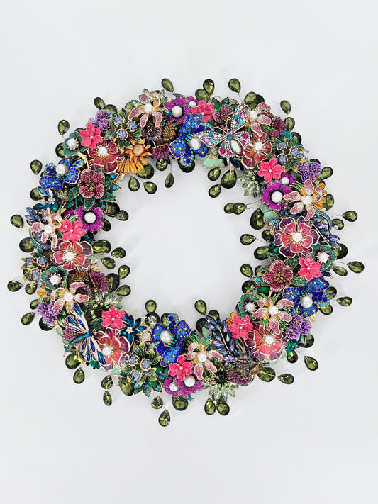 Jeweled wreath with sage green teardrop  rhinestones, pearl-centered florals, jeweled butterflies, and multicolor rhinestone blooms in pink, purple, blue, and fuchsia