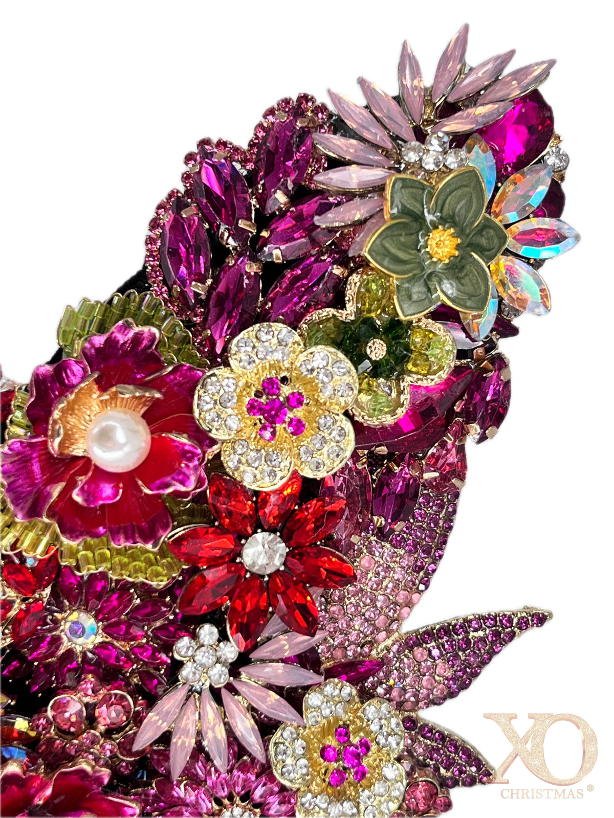 Close-up detail of Pink Jeweled Butterfly Sculpture wing featuring magenta marquise rhinestones, lime green floral brooch, deep fuchsia crystal clusters, and iridescent aurora borealis accents.