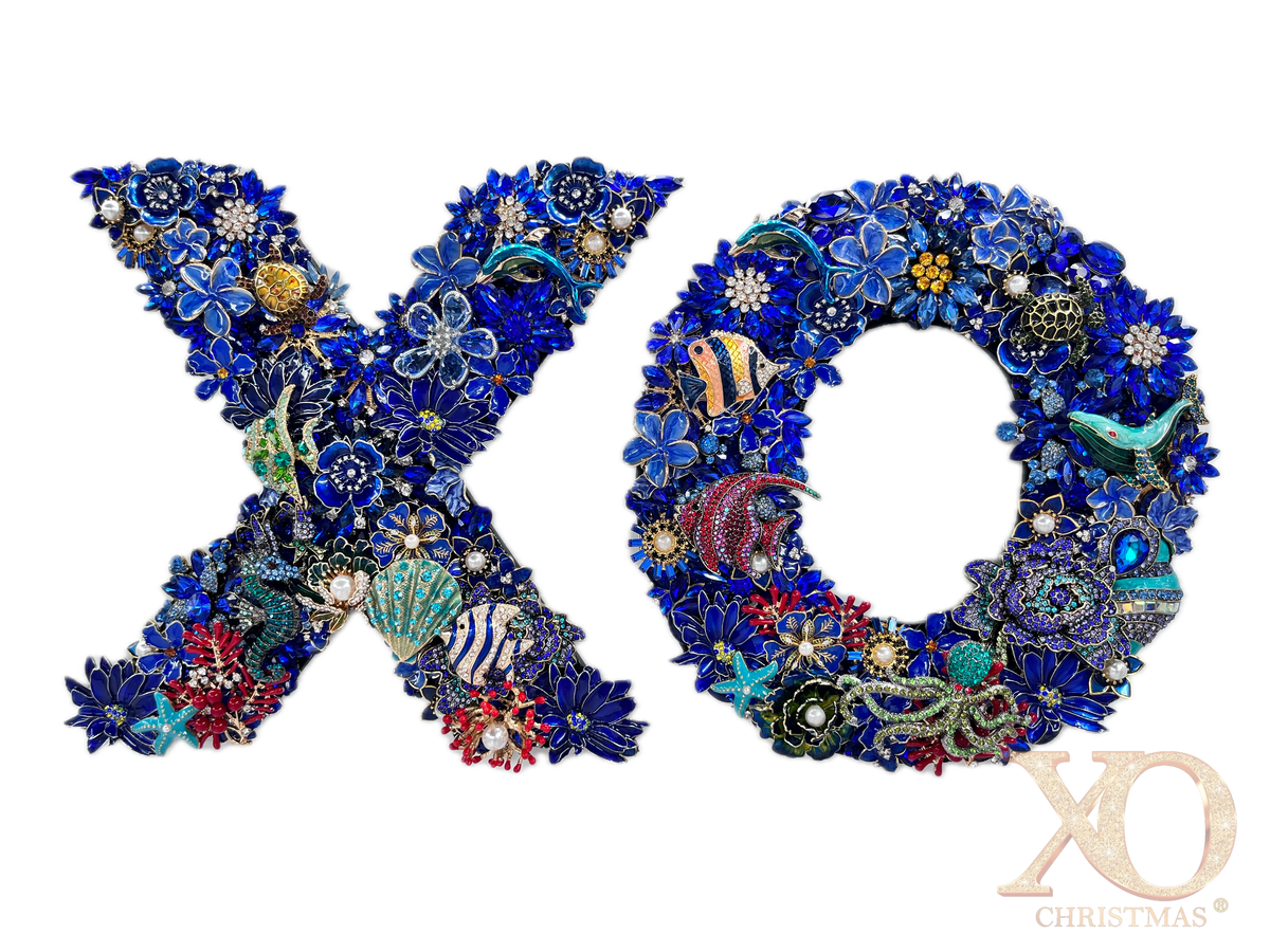 Sapphire blue rhinestone jeweled letter X and O wall art pair with a dolphin, sea turtle, starfish, and coral fish on each letter, faux pearl accents, and coral red and gold details