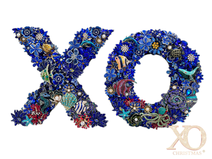 Sapphire blue rhinestone jeweled letter X and O wall art pair with a dolphin, sea turtle, starfish, and coral fish on each letter, faux pearl accents, and coral red and gold details