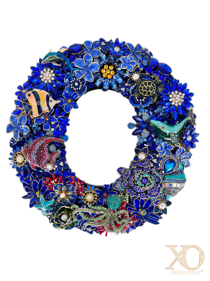Sapphire blue rhinestone jeweled letter O with an octopus, whale, dolphin, and sea turtle detail, accented with faux pearl centers and coral red and gold tones