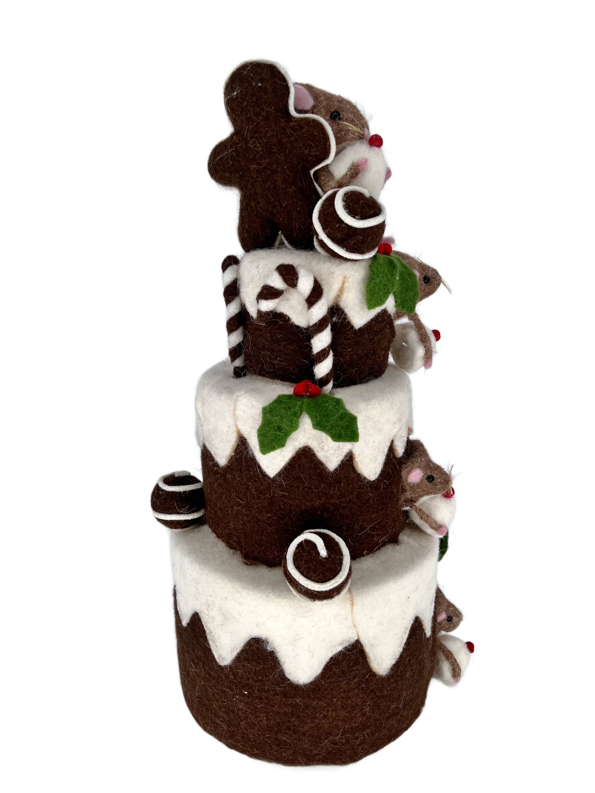 Back angle of felt chocolate tiered cake centerpiece with gingerbread cookie topper, striped candy canes and holly