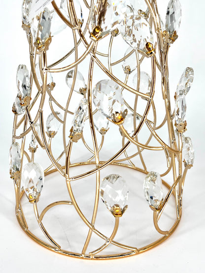 Close-up of the Mark Roberts Crystal Cone Tree's lower half: curved gold wire lattice set with clear faceted teardrop drops in small gold caps, rising from a round gold base ring.