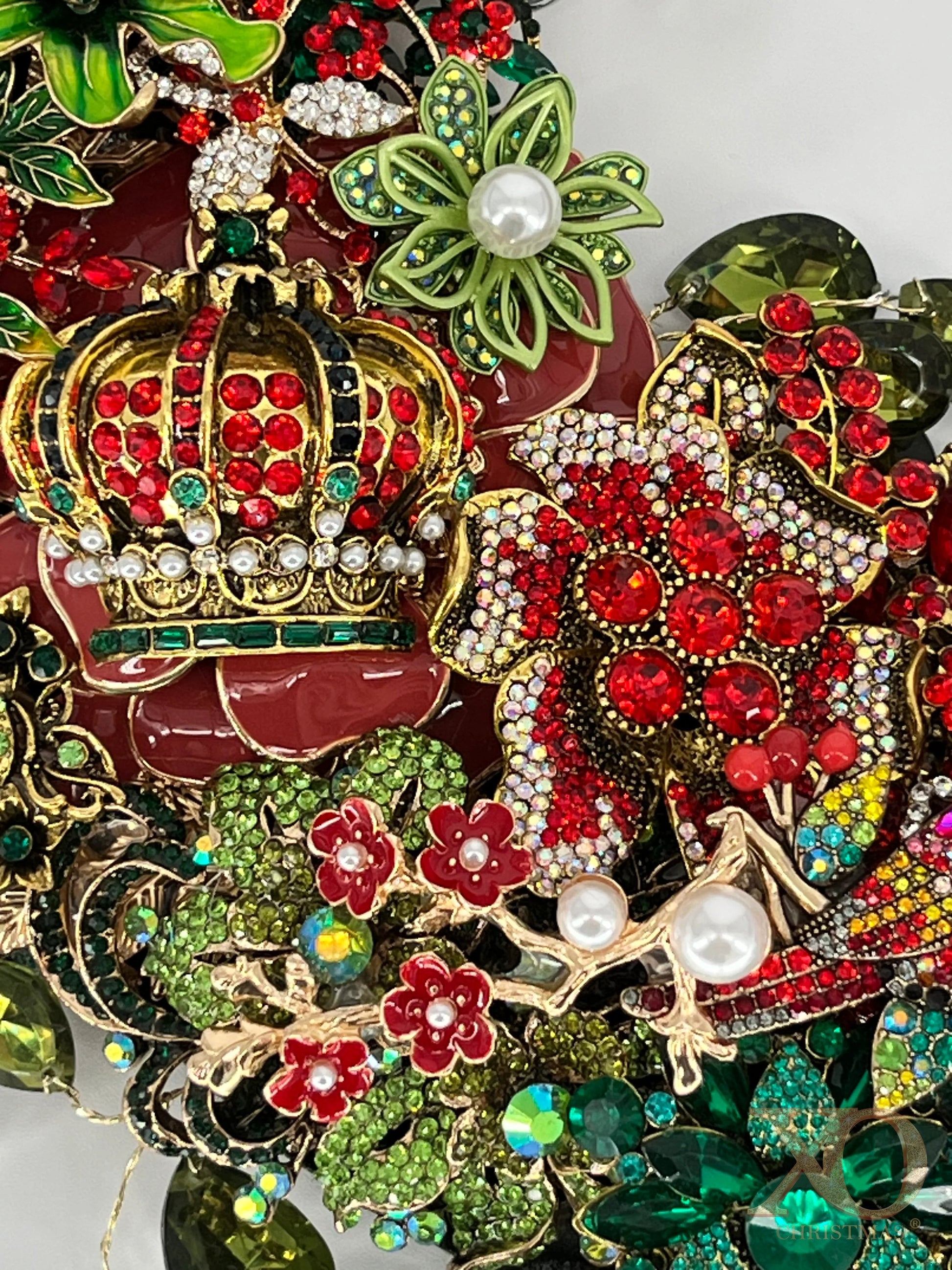 Featuring a jeweled crown in red, green jewels, and faux pearls, surrounded by layers of jeweled florals in rich reds, greens, and gold.