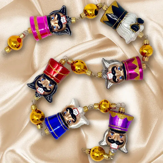 Colorful Broadway Nutcrackers Garland glass ornaments for holiday décor and seasonal displays.