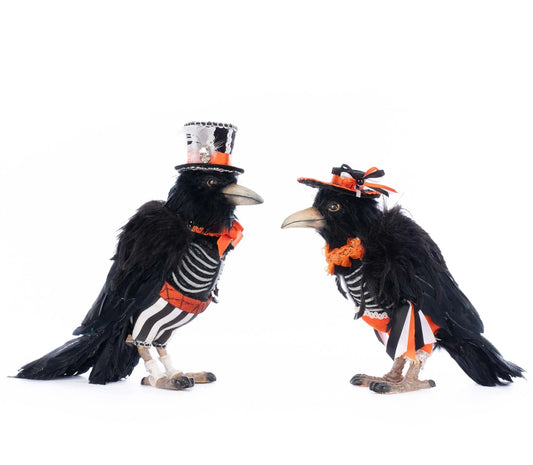 Katherine's Collection Edgar Allen and Poe the Crows Pair shown in full side profile facing each other, displaying the sculpted beaks, sparkling ribcage detail, and striped black-and-white attire on both figures from the side.