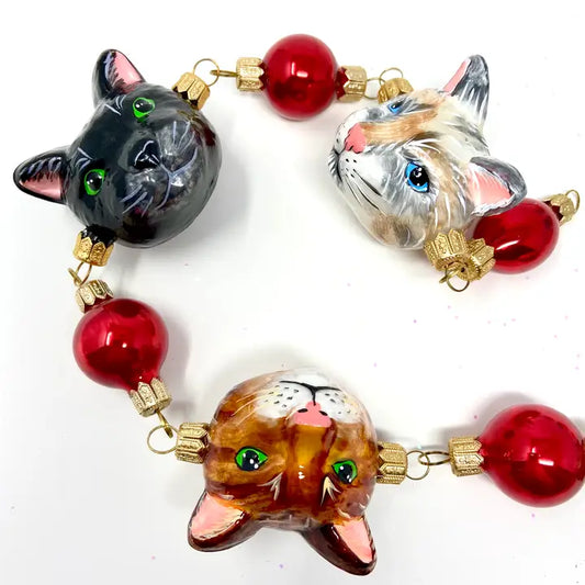 Holiday Cat Faces Garland glass ornaments for holiday décor and seasonal displays.