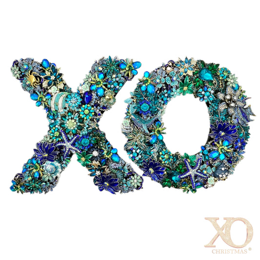 Heavily jeweled XO ocean wreath set in blue, teal, and green, adorned with tropical fish, starfish, and seahorse motifs