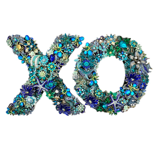Heavily jeweled XO ocean wreath set in blue, teal, and green, adorned with tropical fish, starfish, and seahorse motifs