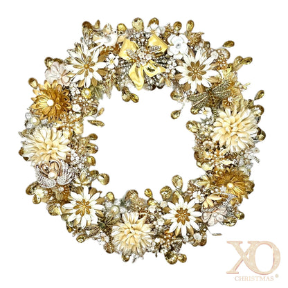 Gold and ivory jeweled wreath with dense clusters of faux pearls, white enamel flowers, champagne rhinestones, jeweled dragonfly, swan, and butterfly, topped with a gold bow with jeweled accents