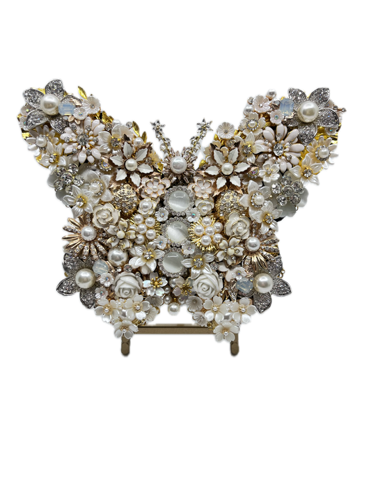 White Pearl Jeweled Butterfly Sculpture displayed on gold easel, adorned with ivory and cream floral brooches, faux pearls, porcelain roses, and crystal accents — handmade in the USA