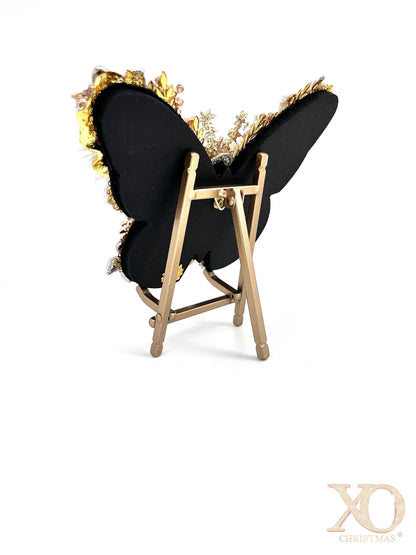Back view of White Pearl Jeweled Butterfly Sculpture on gold easel, showing sleek black backing with gold jeweled edge detail